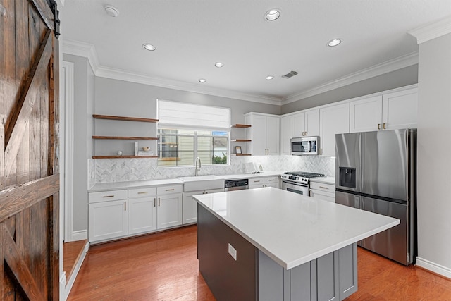 1646 W 13th St, Houston, TX 77008 - kitchen with appliances with stainless steel finishes, open shelves, a sink, white cabinets, and recessed lighting