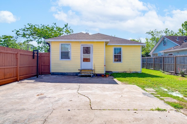611 N Gaillard St, Baytown, TX 77520 - rear view of house featuring a fenced backyard, a patio area, a lawn, and entry steps