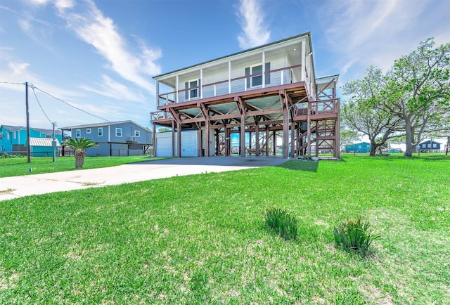 beach home with a carport, a front lawn, driveway, and stairs