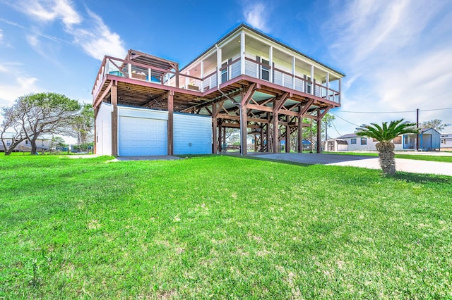 view of front of property featuring a carport, a deck, a front lawn, and a garage