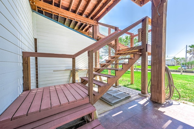 deck with stairway and a patio