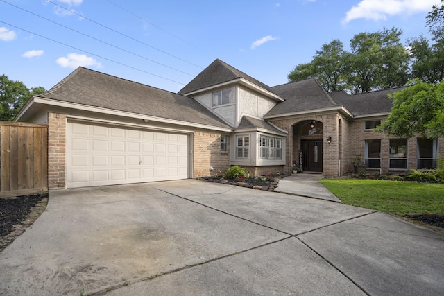 13018 Lentando Ln, Cypress, TX 77429 - view of front of home with brick siding, an attached garage, concrete driveway, and a shingled roof