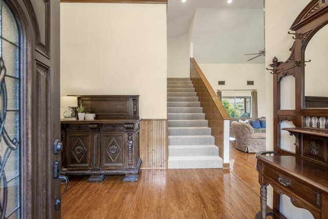 13018 Lentando Ln, Cypress, TX 77429 - entryway with stairway, wood finished floors, ceiling fan, a wainscoted wall, and recessed lighting