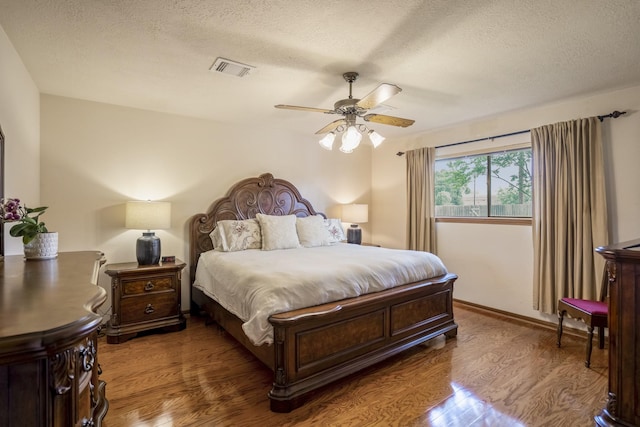 13018 Lentando Ln, Cypress, TX 77429 - bedroom featuring wood finished floors, a textured ceiling, and ceiling fan