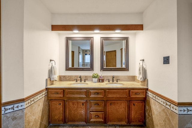 13018 Lentando Ln, Cypress, TX 77429 - bathroom with tile walls, a wainscoted wall, and double vanity