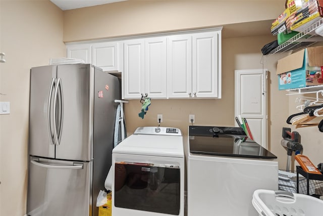 washroom with washing machine and clothes dryer