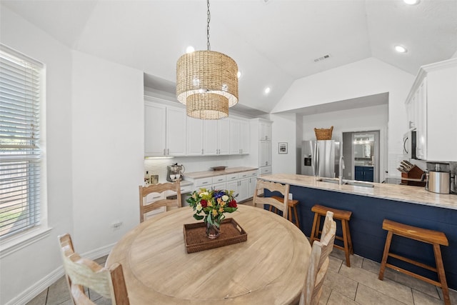 dining space with lofted ceiling, a notable chandelier, recessed lighting, plenty of natural light, and visible vents