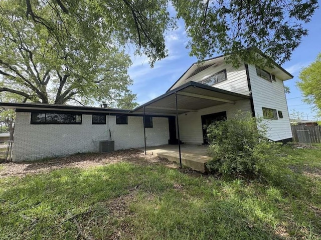 3508 N Robison Rd, Texarkana, TX 75501 - view of front of home with brick siding, central AC unit, fence, and a patio