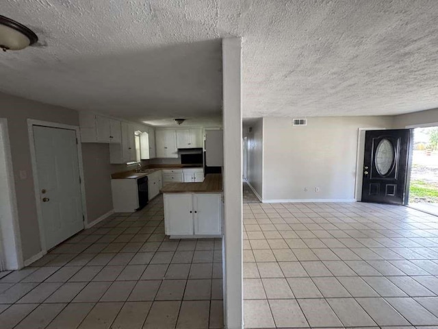 3508 N Robison Rd, Texarkana, TX 75501 - kitchen featuring dishwasher, baseboards, light tile patterned flooring, and white cabinetry