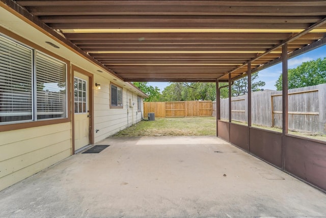view of patio featuring a fenced backyard, an attached carport, and cooling unit