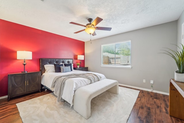 bedroom with ceiling fan, baseboards, and wood finished floors
