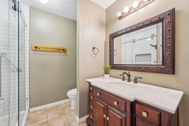 full bathroom featuring a shower stall, toilet, vanity, baseboards, and a textured ceiling