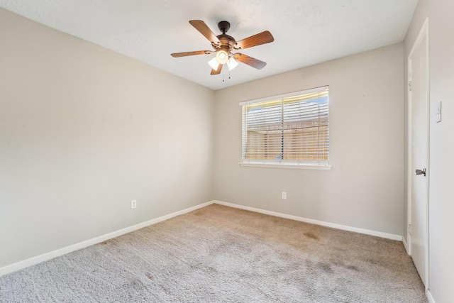 empty room with baseboards, carpet floors, and ceiling fan