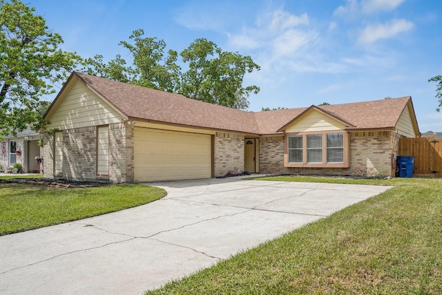 ranch-style house with brick siding, an attached garage, a front lawn, and concrete driveway