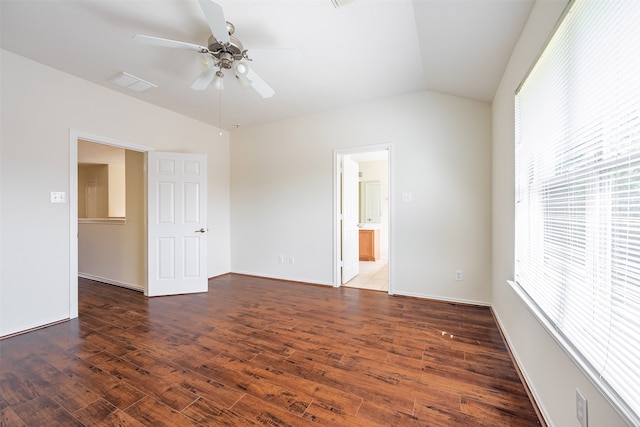 interior space featuring vaulted ceiling, ensuite bath, wood finished floors, and visible vents