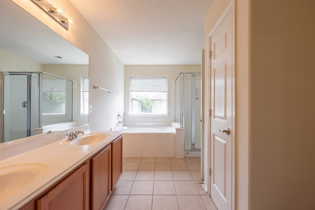 bathroom featuring tile patterned flooring, a sink, and a shower stall