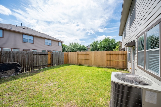 view of yard with a fenced backyard and cooling unit