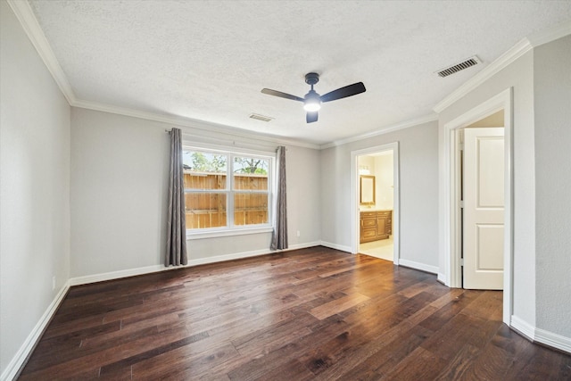 spare room featuring dark wood finished floors, ceiling fan, a textured ceiling, crown molding, and baseboards