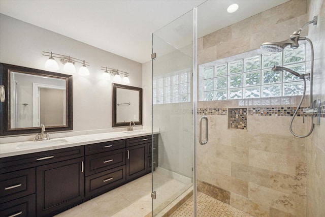 bathroom with a stall shower and double vanity