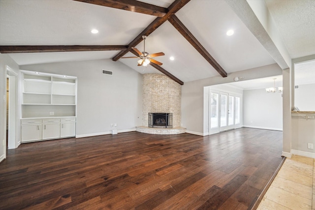 unfurnished living room with a fireplace, a chandelier, a ceiling fan, hardwood / wood-style flooring, and baseboards