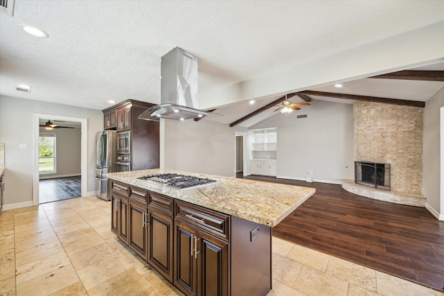kitchen with a ceiling fan, stainless steel appliances, island exhaust hood, a kitchen island, and recessed lighting