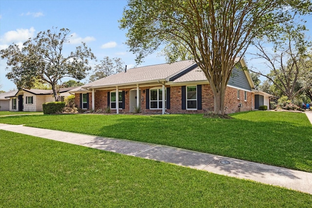 ranch-style house with a front lawn and brick siding