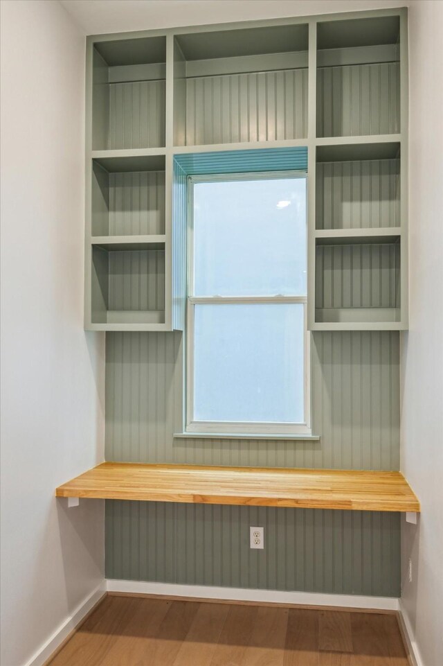 mudroom featuring baseboards and wood finished floors