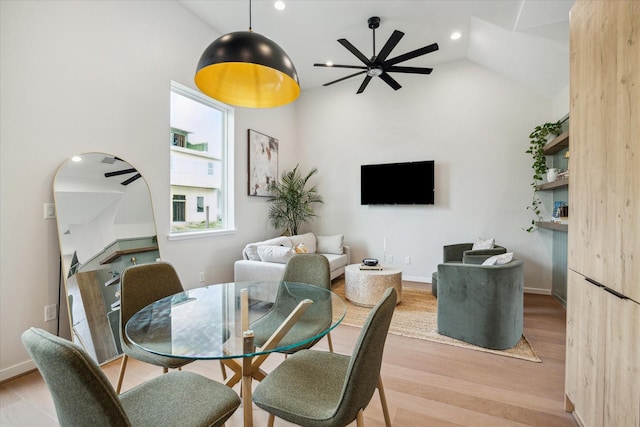 dining area with recessed lighting, vaulted ceiling, a ceiling fan, light wood-type flooring, and baseboards