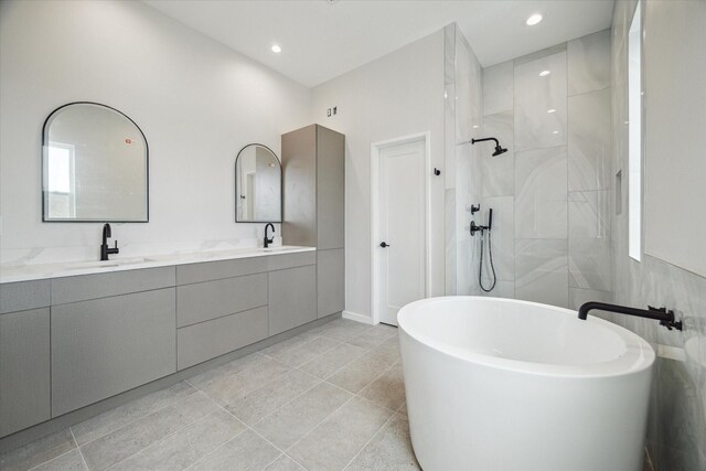 bathroom with walk in shower, a soaking tub, double vanity, tile patterned flooring, and recessed lighting