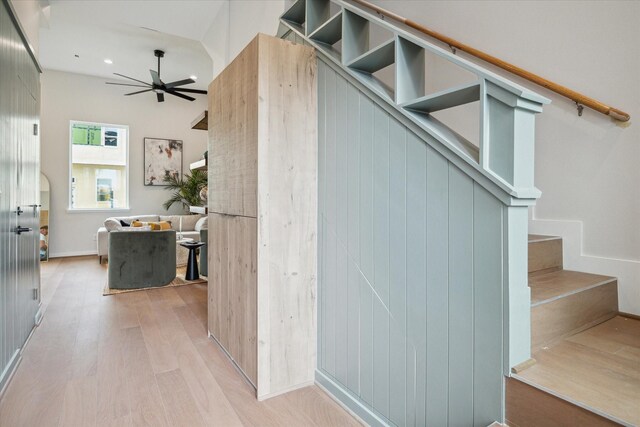 stairway featuring recessed lighting, wood finished floors, and a ceiling fan
