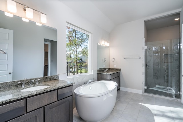 bathroom featuring a soaking tub, tile patterned floors, a stall shower, and a sink