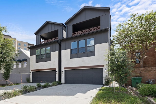 view of front of house with an attached garage, concrete driveway, and a balcony