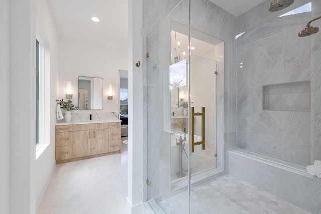 full bath with a marble finish shower, tile patterned flooring, and vanity