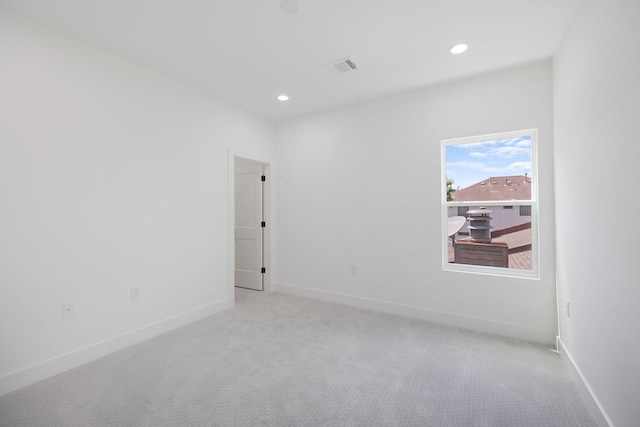 empty room with recessed lighting, carpet floors, and visible vents