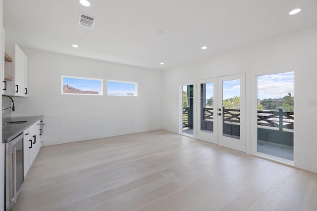interior space featuring recessed lighting, visible vents, a sink, french doors, and light wood-style floors