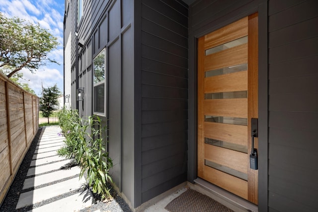 entrance to property featuring fence