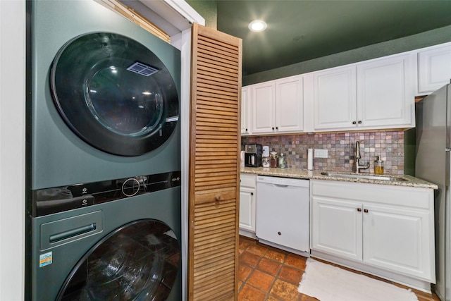 3400 Timmons Ln Unit 68, Houston, TX 77027 - laundry area featuring stacked washer / dryer, dark tile patterned flooring, and recessed lighting
