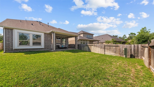 119 Buckeye Dr, Montgomery, TX 77316 - back of property featuring a fenced backyard, brick siding, and a lawn