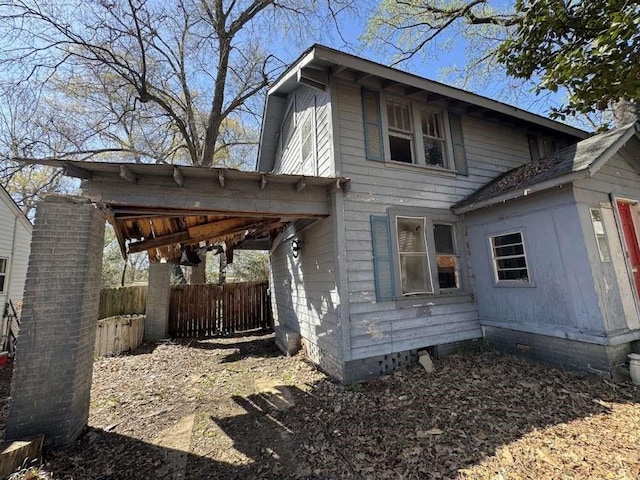 view of property exterior featuring fence