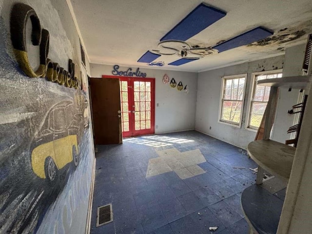 interior space featuring plenty of natural light, french doors, and visible vents