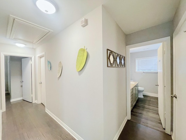 8423 Glen Valley Dr, Houston, TX 77061 - corridor with attic access, wood finished floors, and baseboards