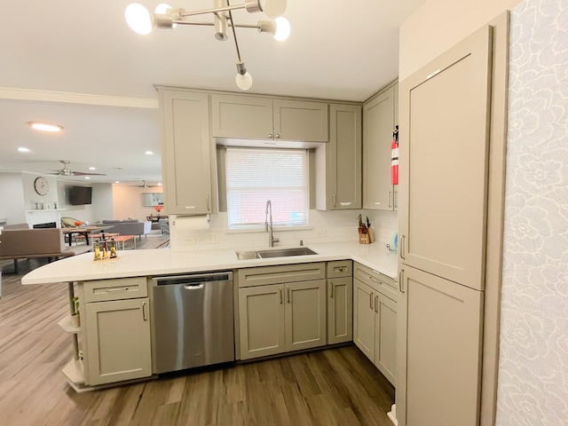 kitchen with stainless steel dishwasher, a sink, open floor plan, light countertops, and dark wood-type flooring