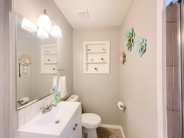 bathroom featuring toilet, built in features, visible vents, crown molding, and vanity