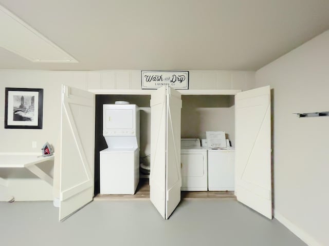 clothes washing area featuring stacked washing maching and dryer and laundry area
