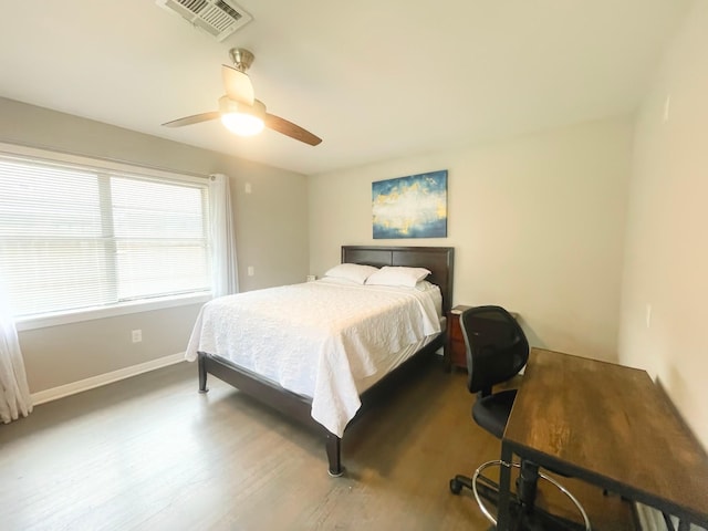 8423 Glen Valley Dr, Houston, TX 77061 - bedroom featuring wood finished floors, a ceiling fan, and baseboards