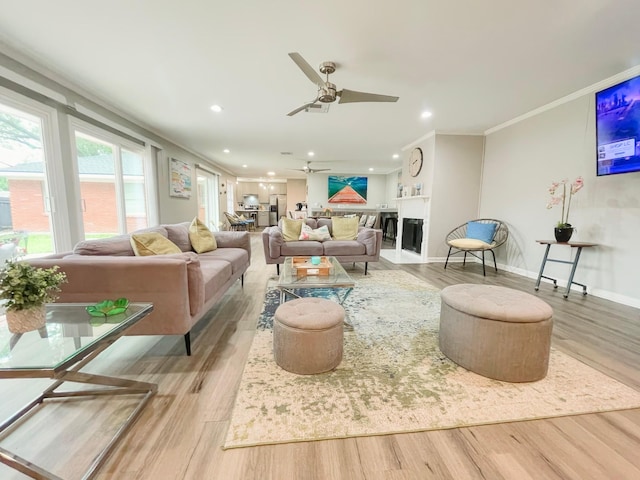 8423 Glen Valley Dr, Houston, TX 77061 - living room featuring wood finished floors, ceiling fan, crown molding, recessed lighting, and baseboards