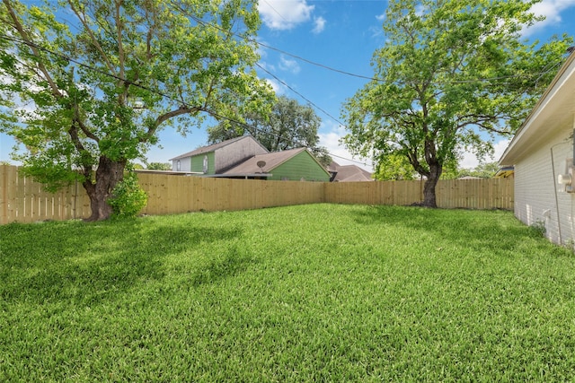 view of yard with a fenced backyard