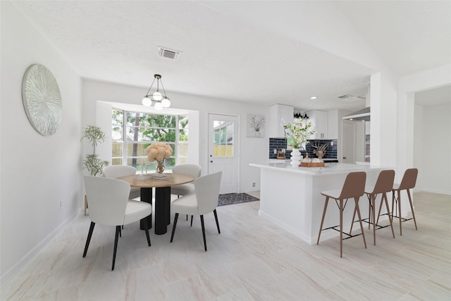dining area featuring baseboards and visible vents