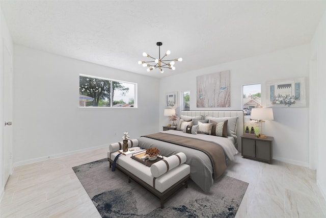 bedroom with a notable chandelier and baseboards