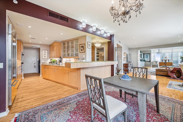 dining space featuring light wood-style floors, recessed lighting, a chandelier, and visible vents